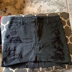 Black denim skirt with rips